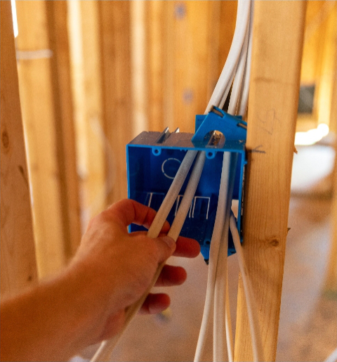 Residential home under construction — rough-in wiring and framing for new build or addition