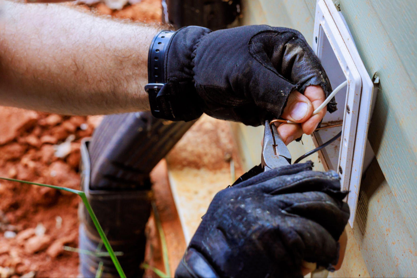 Electrician installing an outdoor outlet for a garage in Durham NC.