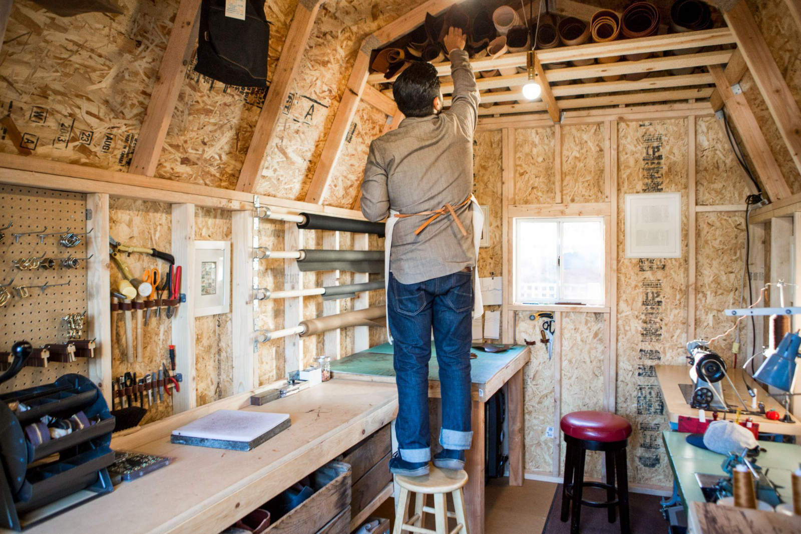Interior of a shed workshop with lighting and power outlets for tools.